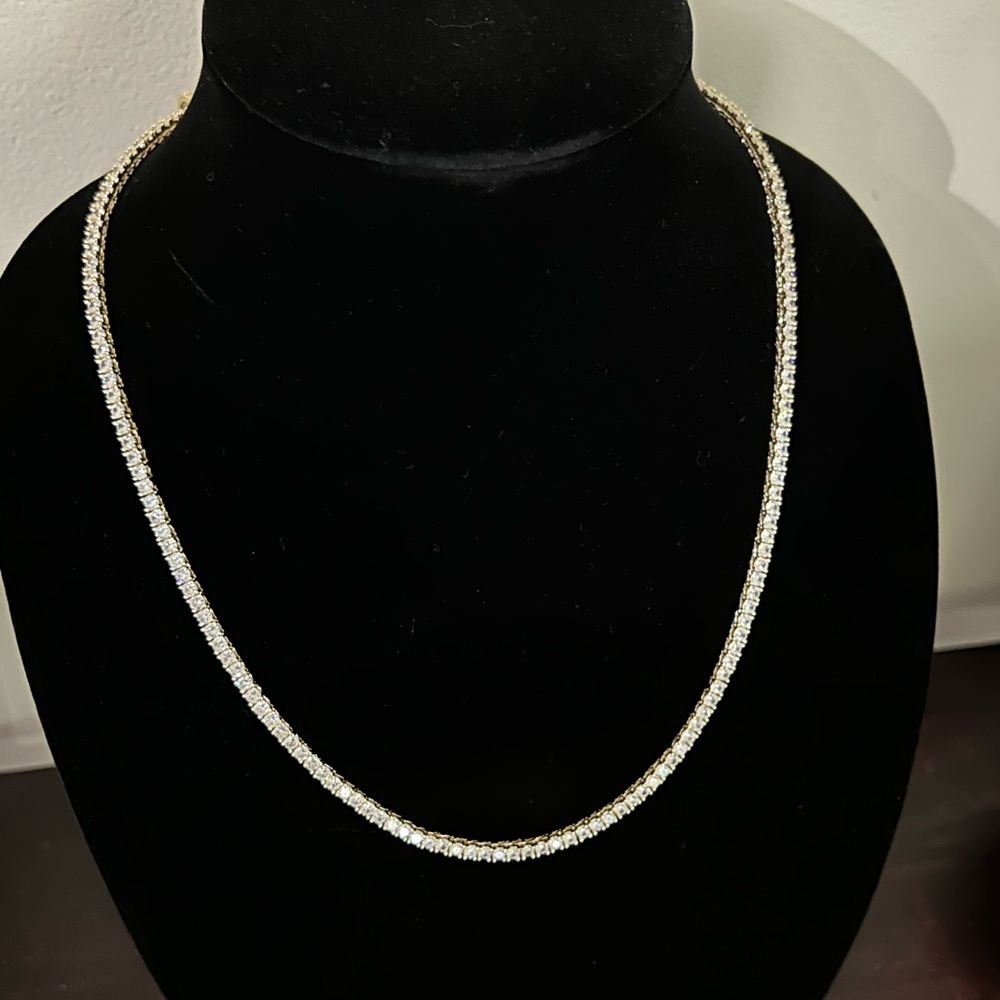 Gold tennis necklace with cross pendant